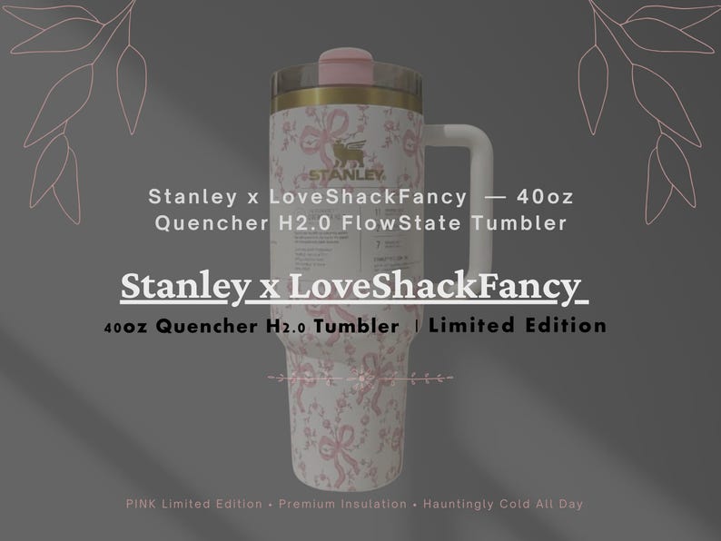 May include: A 40oz Stanley x LoveShackFancy Quencher H2.0 FlowState tumbler featuring a white body with a pink ribbon and floral pattern. The tumbler has a gold-tone rim, a pink lid, and a white handle. Text includes Stanley x LoveShackFancy.