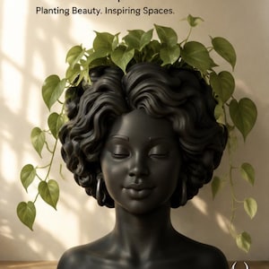 May include: A matte black head-shaped planter featuring sculpted wavy hair and hoop earrings. The planter contains a trailing green pothos plant. Text at the top reads AP-002 | Zuri, Planting Beauty. Inspiring Spaces. A Phoenix Studio logo is at the bottom.