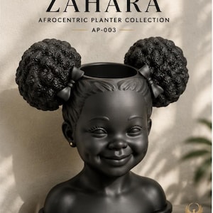 May include: A matte black planter shaped like a child's head with two large afro puffs, each adorned with a small bow. The text ZAHARA AFROCENTRIC PLANTER COLLECTION AP-003 is visible above, and the PHOENIX STUDIO logo is in the bottom corner.