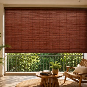 May include: A dark reddish-brown bamboo roller shade covering a large window. The shade features a tightly woven horizontal slat design with a consistent texture, mounted at the top of the window frame to provide light filtration and privacy.