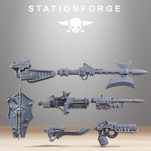 May include: A collection of grey resin miniature wargaming weapon components including a chainsword, a polearm with a large blade, a shield decorated with skulls, a multi-barreled cannon, a long rifle, and a flamethrower, all labeled STATIONFORGE.