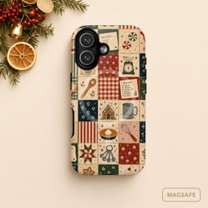 May include: A phone case featuring a patchwork quilt design with holiday baking motifs including gingerbread houses, whisks, measuring spoons, recipe cards, and peppermint candies in red, green, and cream colors. The case includes MagSafe branding.