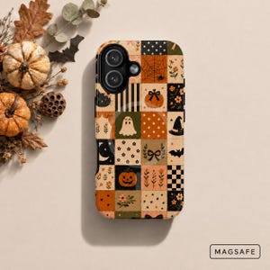 May include: A phone case featuring a patchwork design with Halloween-themed illustrations including pumpkins, ghosts, black cats, bats, spiderwebs, and floral patterns in orange, black, cream, and green. The case includes a MagSafe magnetic ring.