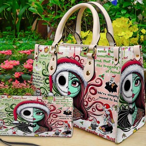 May include: A structured handbag and a matching rectangular wallet featuring a split-face character graphic of Jack Skellington and Sally wearing Santa hats. The design includes red, green, and white patterns with text excerpts from The Nightmare Before Christmas.
