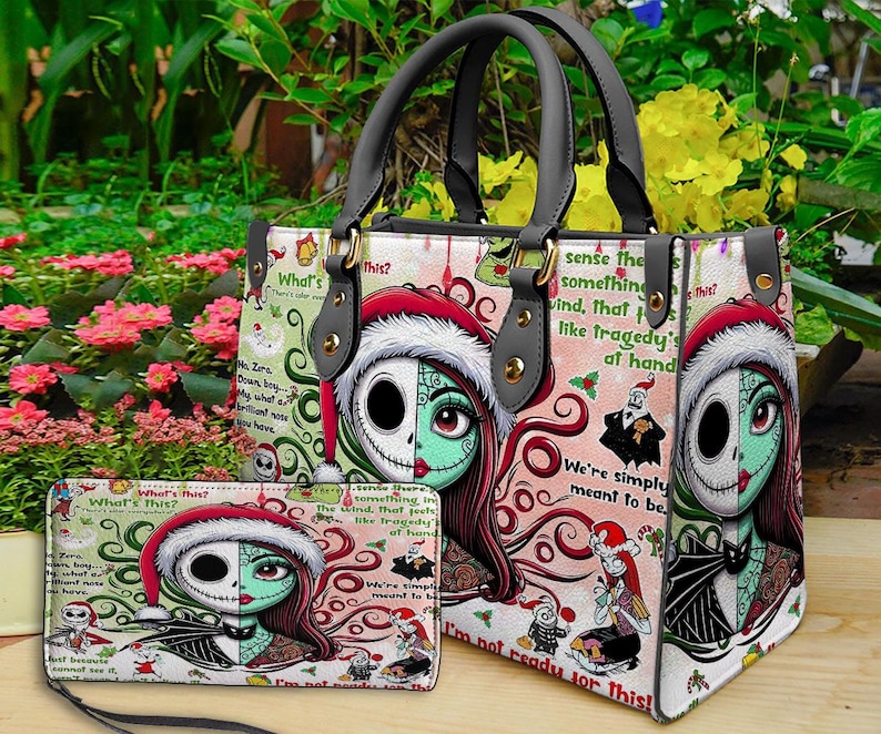 May include: A structured handbag and matching rectangular wallet featuring a split-face character graphic of a skeleton and a stitched-skin figure wearing Santa hats. The design includes red, green, and white patterns with text from a movie.