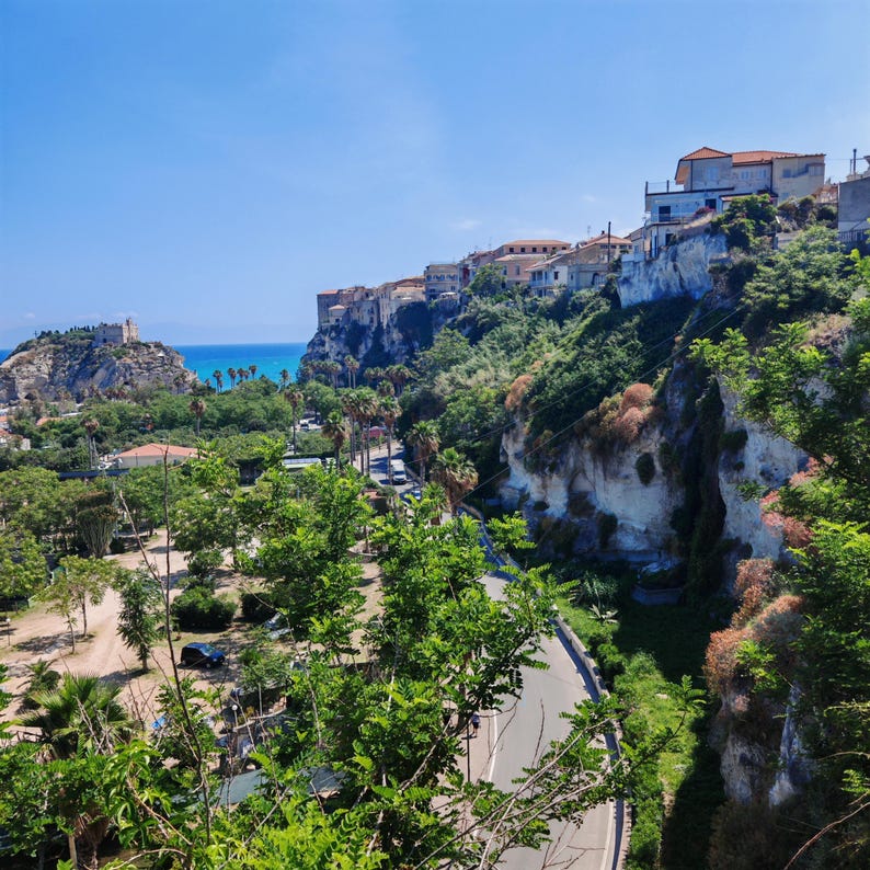 Tropea Calabria Town Square Flowering Trees And Rustic Buildings tropea-calabria-town-square-flowering-trees-and-rustic-buildings