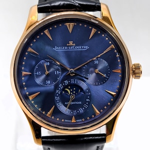 May include: A Jaeger-LeCoultre watch with a rose gold case, a deep blue sunray dial, and a black leather strap. The dial features gold-tone indices, three sub-dials, a moon phase display, and the text Jaeger-LeCoultre, Automatique, and Swiss Made.