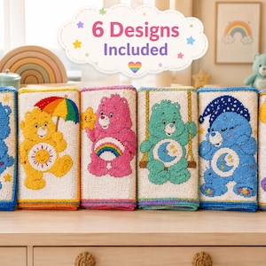 May include: Six rectangular fabric panels featuring embroidered Care Bears characters in blue, yellow, pink, teal, and purple. Each panel displays a unique character with symbols like a trophy, sun, rainbow, moon, and balloons. Text reads 6 Designs Included.