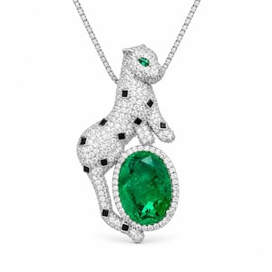 May include: A silver-toned necklace featuring a pendant shaped like a panther covered in small white stones with black square accents and green stone eyes. The panther rests its front paws on a large, oval-shaped, vibrant green gemstone.