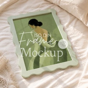 May include: A light green rectangular frame with a wavy, scalloped edge containing an illustration of a person with dark hair in a bun wearing a light-colored garment. The text ISO, DIN Frame Mockup and a small circle with PSD File are visible.