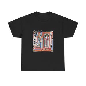 May include: A black short-sleeved t-shirt featuring a central graphic print of a complex electronic circuit board. The design displays a detailed layout of interconnected red, blue, and yellow wiring paths, integrated chips, and metallic components.