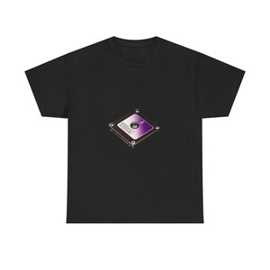 May include: A black short-sleeved t-shirt featuring a central graphic of a square computer hard drive. The hard drive is depicted in a metallic silver and purple gradient colour scheme with visible screws at the corners and a central circular hub.