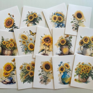 May include: A collection of 13 cards featuring watercolor paintings of sunflowers in various arrangements. Some sunflowers are in vases, others in baskets, and some are growing in the ground. The cards are all white with a white border.