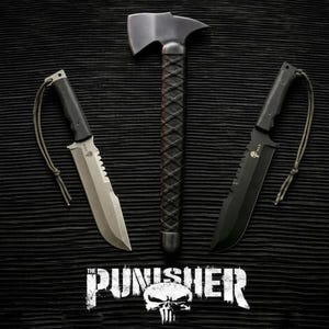 May include: A tactical set featuring a black hatchet with a wrapped handle flanked by two knives with lanyards, one with a silver blade and one with a black blade. Each knife features a skull logo on the blade. The text THE PUNISHER with a skull icon is centered below the tools.