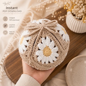 May include: A crochet pattern for a hat featuring a daisy motif. The hat is constructed from beige yarn with white and yellow daisy flower squares. The text on the image reads Instant PDF DOWNLOAD, Instant Pdf download, crochet pattern, and easy to follow.