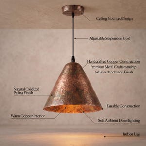 May include: A ceiling-mounted pendant light featuring a hammered copper shade with a natural oxidized patina finish. The fixture includes an adjustable black suspension cord, a warm copper interior, and provides soft ambient downlighting.