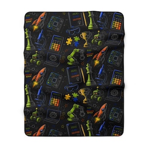 May include: A black blanket featuring a repeating pattern of colorful science and technology icons including orange rockets, green chess pieces, blue microscopes, calculators, robots, robotic arms, trophies, and notebooks with the text IDEAS PLANS SOLUTIONS.