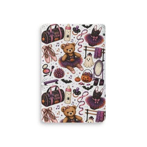 May include: A white fabric pattern featuring a repeating Halloween-themed design with a teddy bear in a tutu, ballet slippers, a duffel bag labeled BOO CREW, a baby bottle with a spider, a ghost, a pumpkin bucket, a mirror, and musical notes.