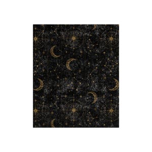May include: A black fabric featuring a repeating celestial pattern with gold-colored crescent moons, multi-pointed stars, and circular navigational compass designs. The background has a mottled, dark gray texture resembling a night sky.