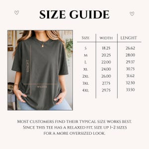 May include: A size guide chart for a charcoal gray t-shirt. The chart lists sizes S through 4XL with corresponding width and length measurements in inches. A visual diagram shows a t-shirt with lines indicating where width and length are measured.