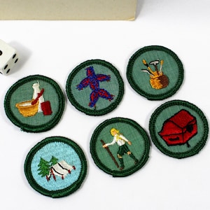 May include: A white ceramic mug with a black handle and the text "But First, Coffee" in a black, bold font. The mug is sitting on a wooden surface. The mug is 4 inches tall.