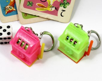 Two Vintage Novelty Mechanical Slot Machine Keychain Charms with Moving Reels