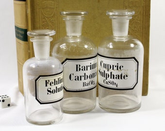 Three Vintage Clear Glass German Pharmacy Bottles with Glass Stoppers and Labels: Barium Carbonate, Cupric Sulphate, Fehling's Solution