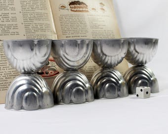 Eight Vintage Aluminum Fluted Shell Gelatin Molds