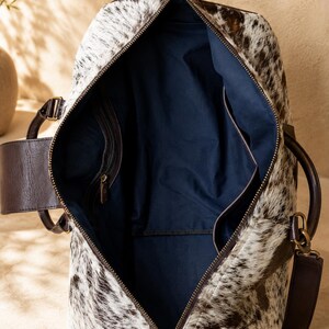 Luxury cowhide duffle bag, hair on hide travel bag, full grain leather weekender, overnight bag men, overnight bag women, luxury travel bag, cowhide weekender bag, carry on duffle, western travel bag, premium leather duffle, handcrafted travel bag, genuine cowhide luggage, luxury weekend bag