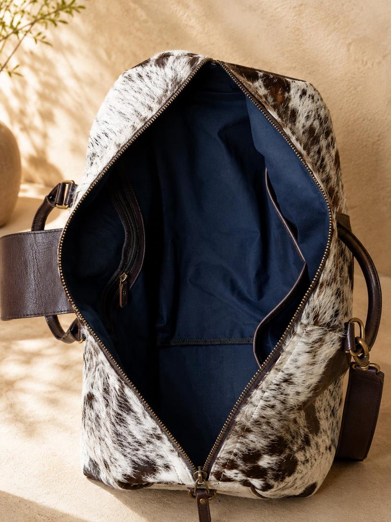 Luxury cowhide duffle bag, hair on hide travel bag, full grain leather weekender, overnight bag men, overnight bag women, luxury travel bag, cowhide weekender bag, carry on duffle, western travel bag, premium leather duffle, handcrafted travel bag, genuine cowhide luggage, luxury weekend bag