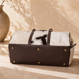 Luxury cowhide duffle bag, hair on hide travel bag, full grain leather weekender, overnight bag men, overnight bag women, luxury travel bag, cowhide weekender bag, carry on duffle, western travel bag, premium leather duffle, handcrafted travel bag, genuine cowhide luggage, luxury weekend bag