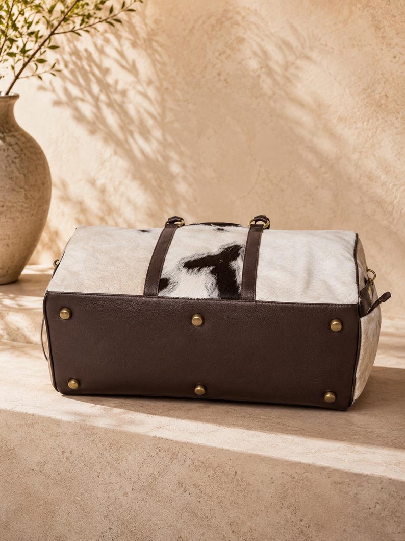 Luxury cowhide duffle bag, hair on hide travel bag, full grain leather weekender, overnight bag men, overnight bag women, luxury travel bag, cowhide weekender bag, carry on duffle, western travel bag, premium leather duffle, handcrafted travel bag, genuine cowhide luggage, luxury weekend bag