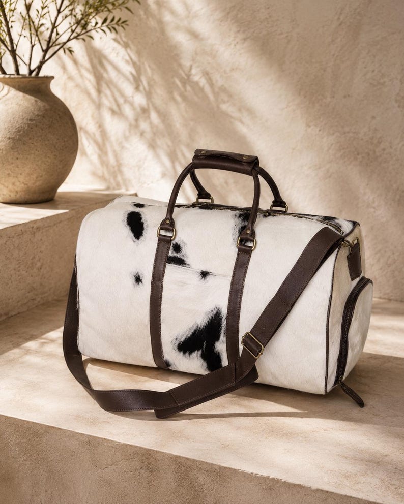 Luxury cowhide duffle bag, hair on hide travel bag, full grain leather weekender, overnight bag men, overnight bag women, luxury travel bag, cowhide weekender bag, carry on duffle, western travel bag, premium leather duffle, handcrafted travel bag, genuine cowhide luggage, luxury weekend bag