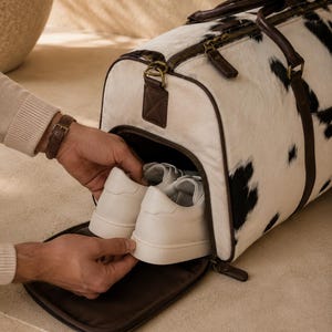 Luxury cowhide duffle bag, hair on hide travel bag, full grain leather weekender, overnight bag men, overnight bag women, luxury travel bag, cowhide weekender bag, carry on duffle, western travel bag, premium leather duffle, handcrafted travel bag, genuine cowhide luggage, luxury weekend bag