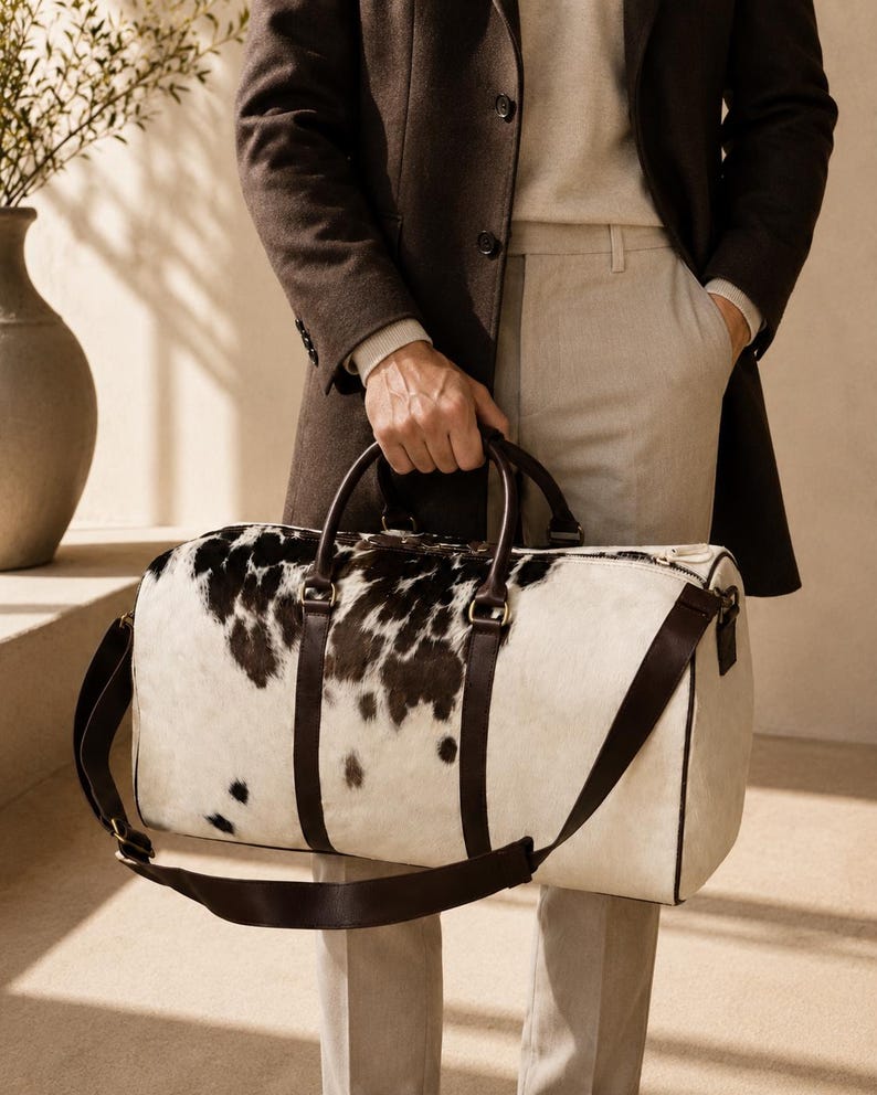 Luxury cowhide duffle bag, hair on hide travel bag, full grain leather weekender, overnight bag men, overnight bag women, luxury travel bag, cowhide weekender bag, carry on duffle, western travel bag, premium leather duffle, handcrafted travel bag, genuine cowhide luggage, luxury weekend bag
