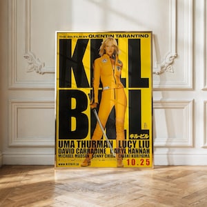May include: A rectangular movie poster for Kill Bill featuring a person in a yellow jumpsuit holding a sword. The background is bright yellow with large black text reading KILL BILL. The poster includes cast names and the date 10.25 in red.
