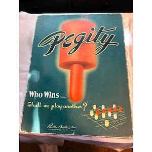 May include: A rectangular board game box cover titled Pegity in large black script. The background is dark teal with a large orange cylindrical graphic. Text reads Who Wins and Shall we play another? with a grid illustration and Parker Brothers Inc.