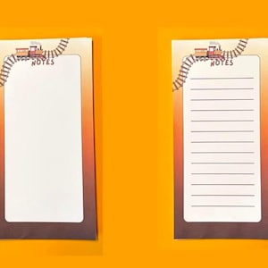 May include: Two rectangular note pads with a gradient orange background. Each pad features a graphic of a steam train on tracks at the top left corner and the word NOTES printed below it. One pad is blank, and the other has horizontal lines.