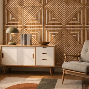 Puede incluir: Un aparador de madera con dos puertas correderas blancas y tres cajones blancos, coronado por una lámpara verde en forma de seta y una fila de libros. Al lado hay un sillón tapizado en gris claro frente a un panel de pared de madera geométrico.