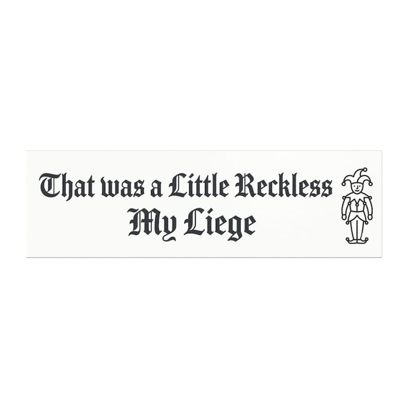 May include: A rectangular white sticker featuring the black text "That was a Little Reckless My Liege" in a gothic-style font. To the right of the text is a simple black line drawing of a jester wearing a traditional cap with bells.
