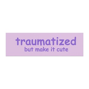 May include: A rectangular sticker with a light purple background featuring the dark purple text "traumatized but make it cute" in a rounded, sans-serif font. The text is centered on the sticker, with the word traumatized on the top line.