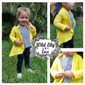 May include: A yellow cardigan with a long, asymmetrical hemline. The cardigan is worn over a striped shirt and blue leggings. The image includes the text "Wild Lily Lace".