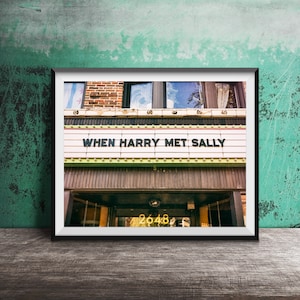May include: A framed photograph of a building with a sign that reads "When Harry Met Sally". The building is made of brick and has a wooden door with the number "2648" above it.