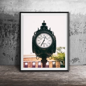 May include: A black clock tower with a white face and black hands. The clock face reads "La Grange 1879". The clock is framed in a black frame.