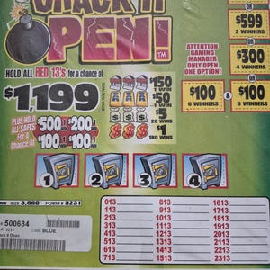 May include: A green Crack It Open game card featuring a black bomb graphic, four numbered safe illustrations, and various prize tiers. The card includes text such as Attention Gaming Manager Only Open One Option and lists numbers from 013 to 2313.