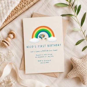 May include: A cream-coloured birthday invitation card featuring a colourful rainbow, two cartoon puffins, and white clouds. The text reads: NICO'S FIRST BIRTHDAY, Let's have a PUFFIN fun time!, August 31, 2026 1:00 pm, 123 anywhere st., any city, RSVP to Jessica at 416-123-9076.