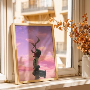 May include: A rectangular framed art print featuring a stylized illustration of a character with dark hair and a red scarf, standing against a vibrant pink and purple sunset sky with clouds and small birds flying in the distance.