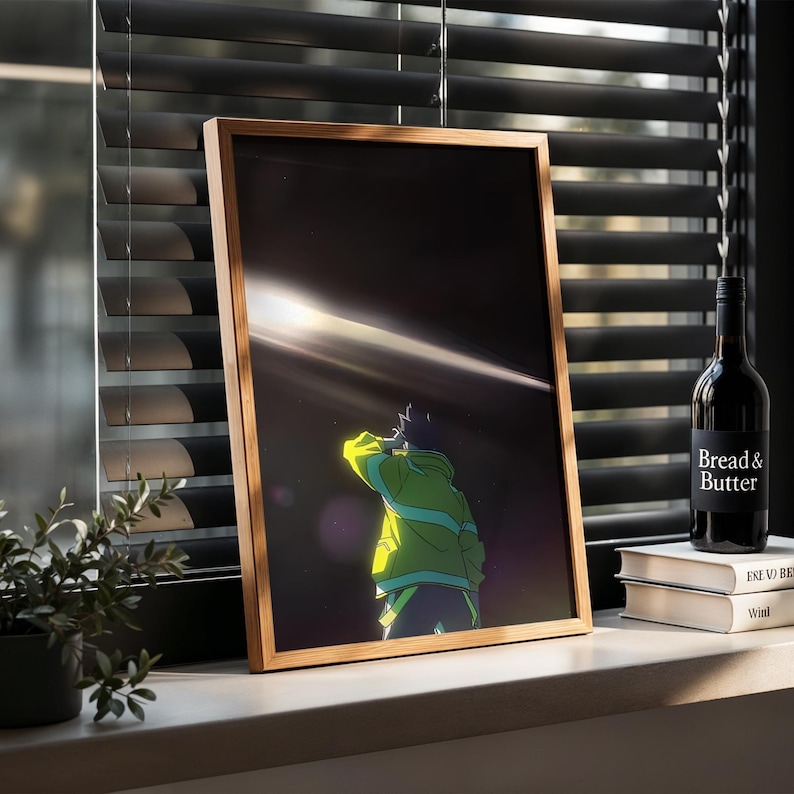 May include: A framed vertical art print featuring a stylized illustration of a figure in a bright neon green jacket standing against a dark background with a horizontal beam of light. The frame is light-colored wood with a simple, clean profile.