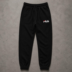 May include: Black sweatpants featuring an elastic waistband with a drawstring and ribbed cuffs at the ankles. The FILA logo is embroidered in white and red on the upper left thigh. The fabric has a smooth texture and a consistent solid black color.