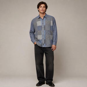 May include: A long-sleeved button-down shirt featuring a patchwork design of blue denim and grey plaid fabric panels, paired with straight-leg charcoal black denim jeans and black leather shoes, creating a coordinated casual outfit.